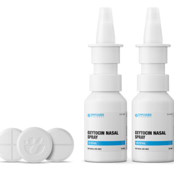 Two bottles of Oxytocin Nasal Spray lined up next to 3 large pills.