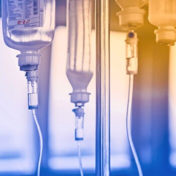 A blue and orange-toned image of IV equipment.
