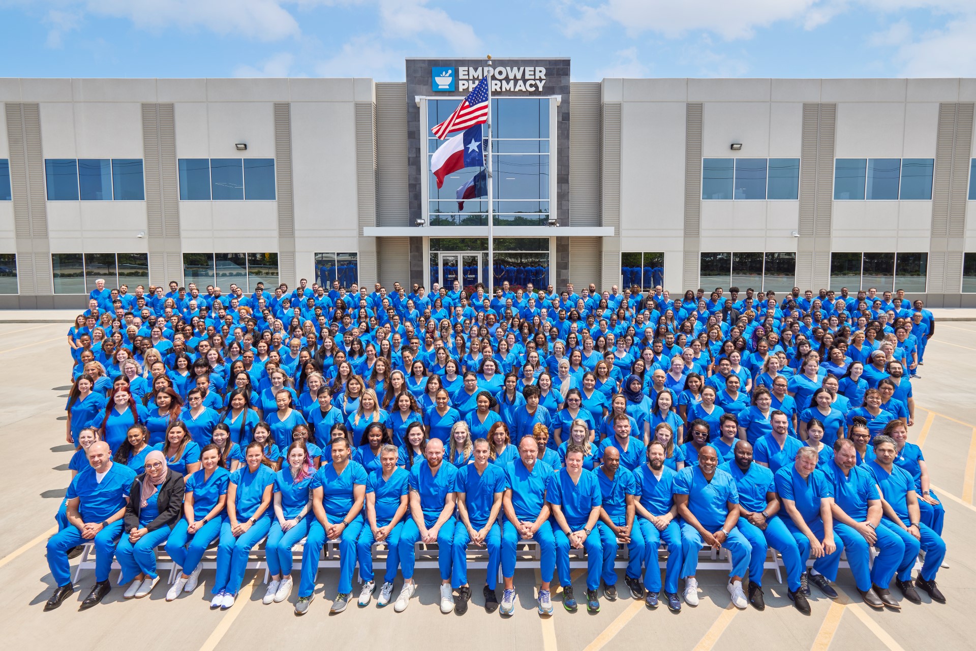 A picture of a large group of employee in front of empower pharmacy