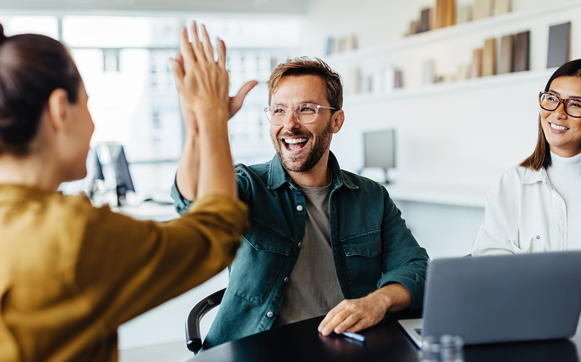 A smiling man high fiving a woman