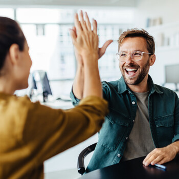 A smiling man high fiving a woman