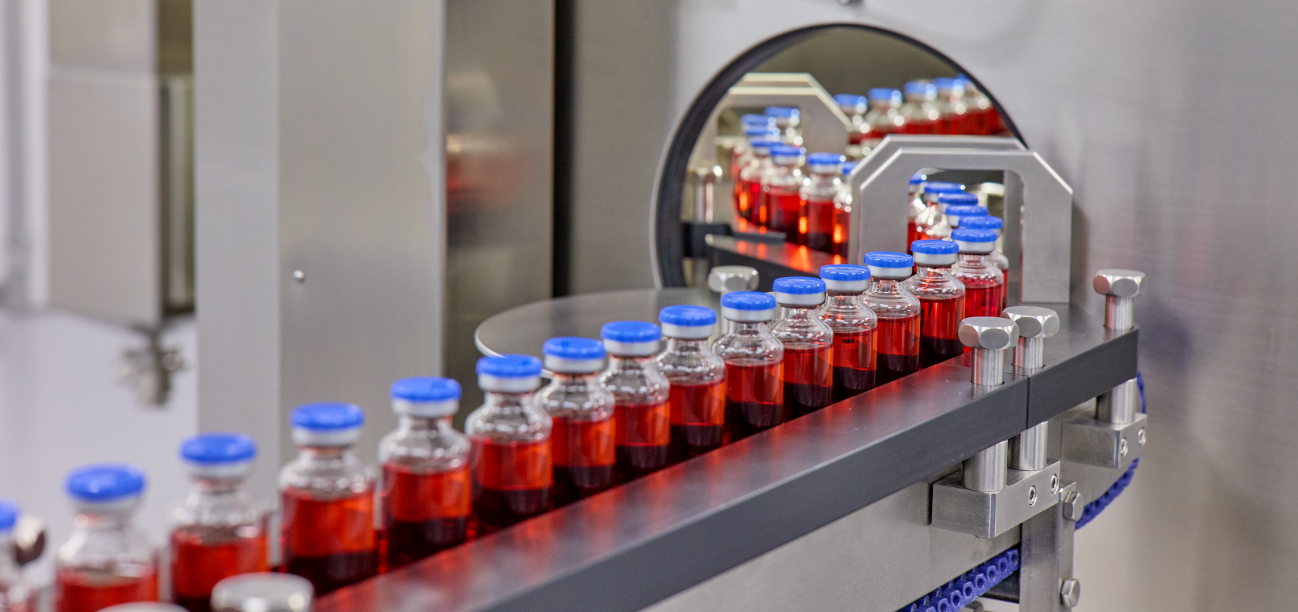 Vials of liquid in a line on a machine.