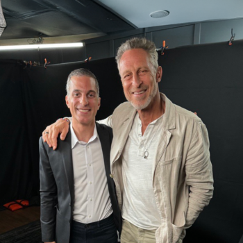 Two men, one in fancy attire the other in more casual clothes