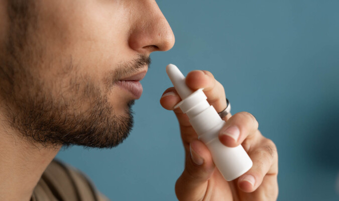 man using nasal spray