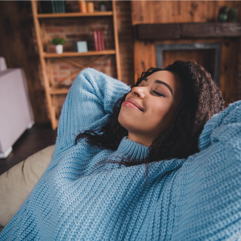 woman sitting in chair smiling with eyes closed