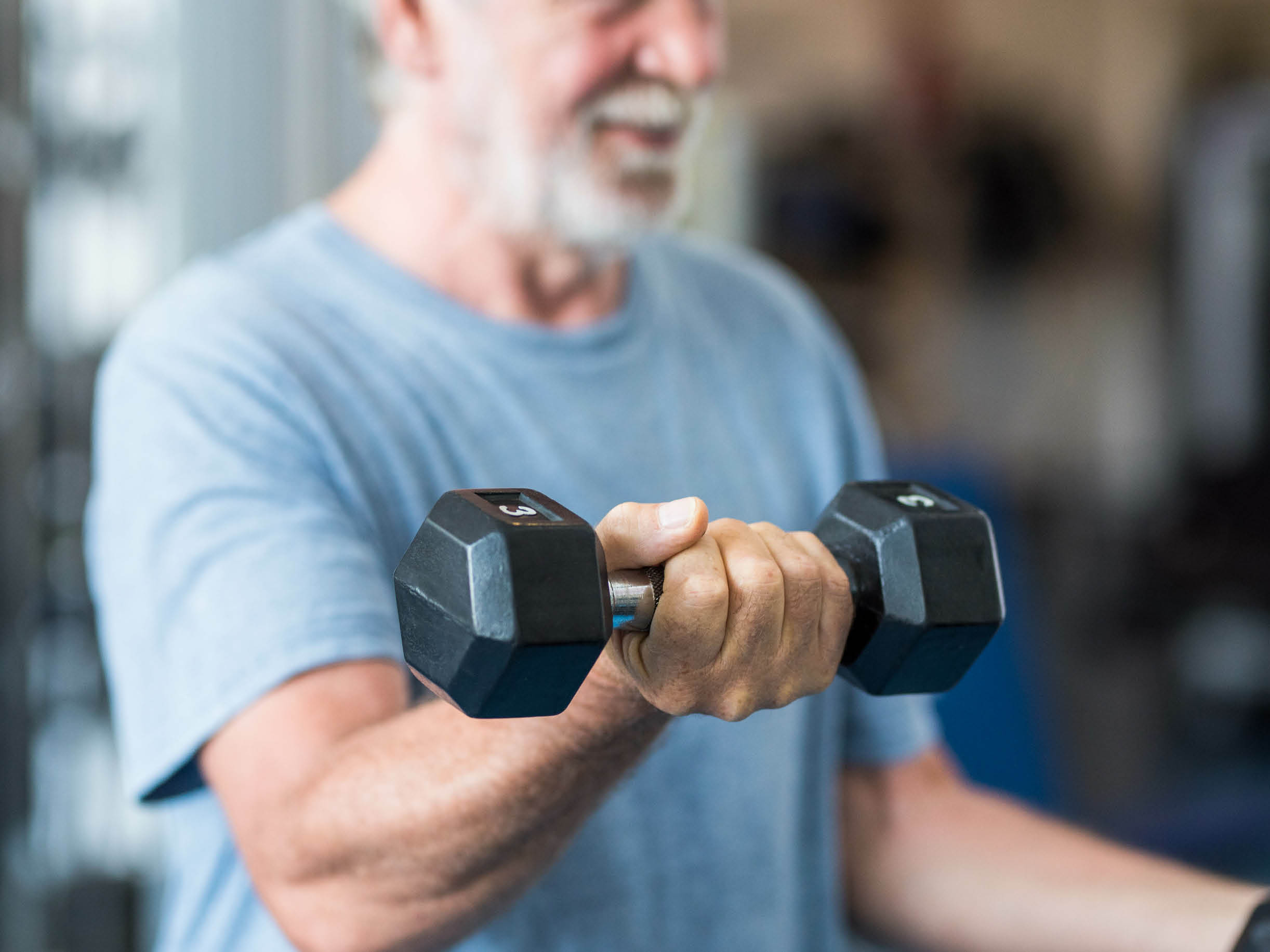 mature man lifting weights